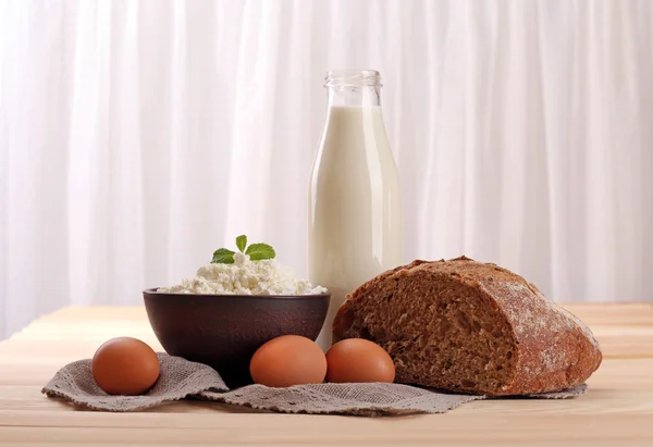 Tasty dairy products on table on fabric background — Stock Photo, Image