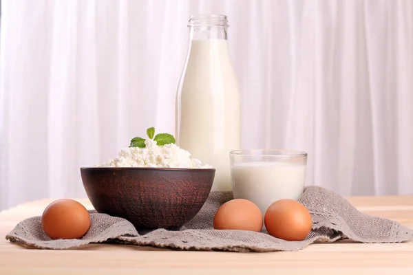 Tasty dairy products on table on fabric background — Stock Photo, Image