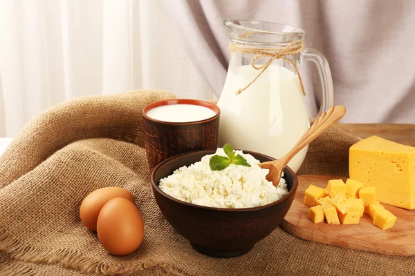 Tasty dairy products on table on fabric background — Stock Photo, Image