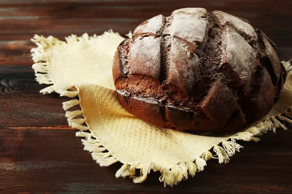 Pane fresco su tovagliolo su sfondo di legno — Foto Stock