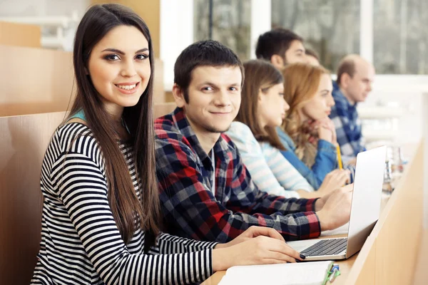 Group of students using gadgets in classroom Stock Picture