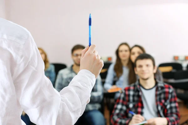 Group of students sitting in classroom and  listening teacher — Stock Photo, Image