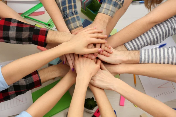 United hands of business team on workspace background top view — Stock Photo, Image