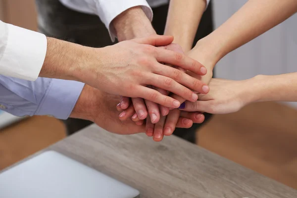 United hands of business team on workspace background — Stock Photo, Image