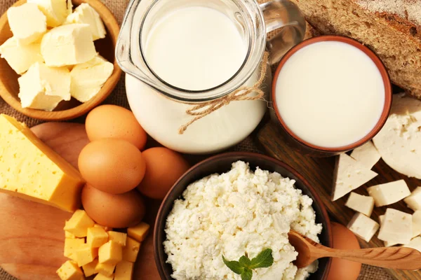 Tasty dairy products with bread on table close up — Stock Photo, Image