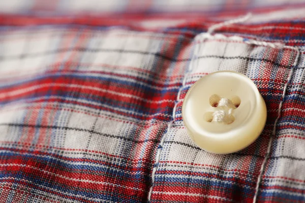 Button on clothes close up