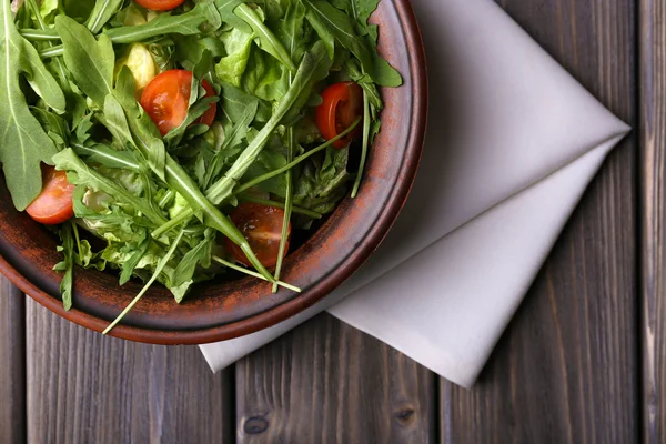 Insalata con rucola e pomodorini sul tavolo di legno — Foto Stock