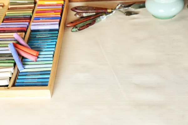 Colorful chalk pastels in box with palette knifes close up — Stock Photo, Image