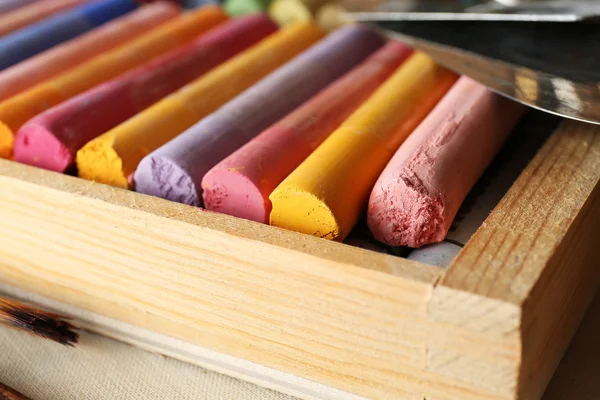 Colorful chalk pastels in box with palette knifes close up — Stock Photo, Image