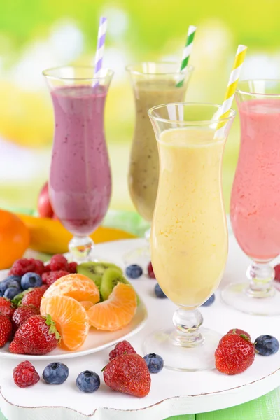 Delicious berry cocktails on table on bright background — Stock Image Delicious berry cocktails on table on bright background Royalty Free Stock Photos