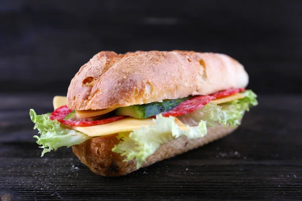 Fresh and tasty sandwiches with cheese and vegetables on wooden background — Stock Photo, Image