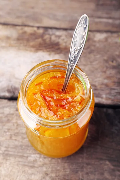 Jar of tasty jam on wooden background — Stock Photo, Image