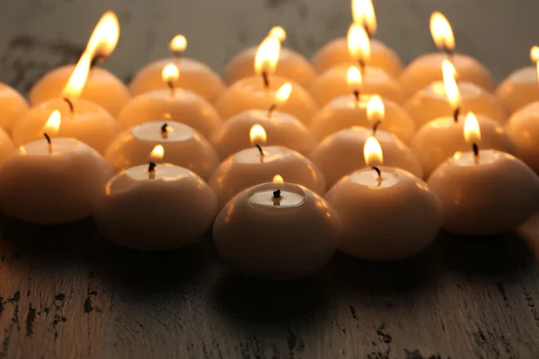 Burning candles on wooden table close-up — Stock Photo, Image