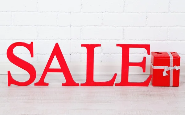 Sale with gift on floor in room — Stock Photo, Image
