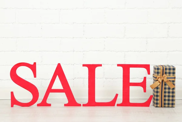 Sale with gift on floor in room — Stock Photo, Image