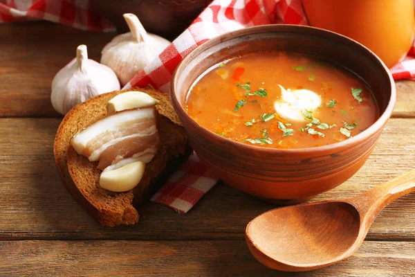 Ukrainian beetroot soup - borscht, on napkin, on wooden background — Stock Photo, Image