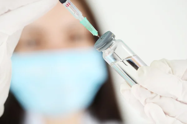 Ampule and syringe in hands — Stock Photo, Image