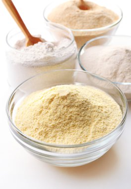 Different types of flour in bowls close up clipart