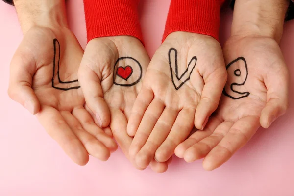 Hands of couple with inscription Love, close-up view — Stock Photo, Image