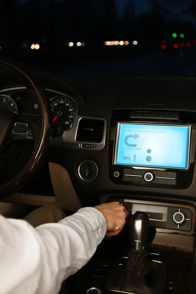 Man driving his modern car at night in city, close-up — Stock Photo, Image