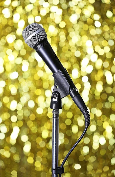 Microphone on stand on golden background — Stock Photo, Image