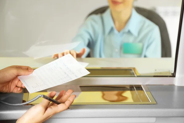 Teller window with working cashier — Stock Photo, Image