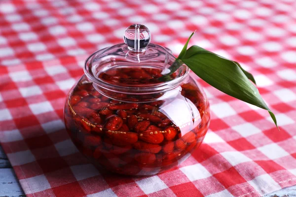 Jar of goji berry jam on napkin on table close up — Stock Photo, Image