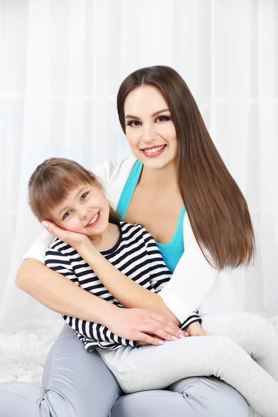 Two girls smiling on light background — Stock Photo, Image