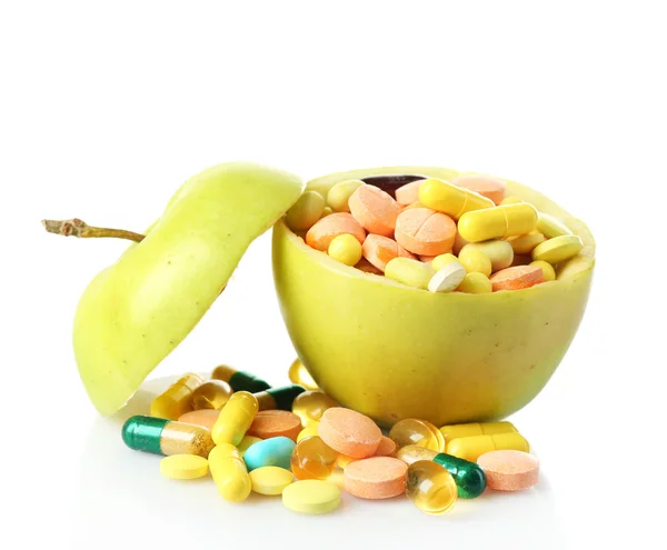Mela e pillole colorate, isolate su bianco — Foto Stock
