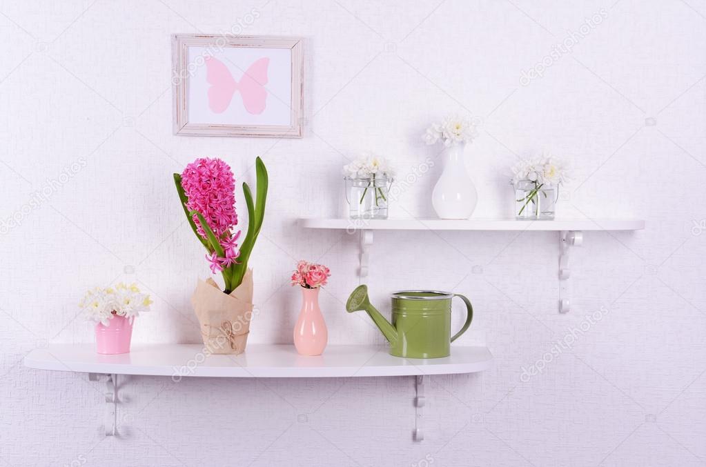 Flower on shelves on white wall background