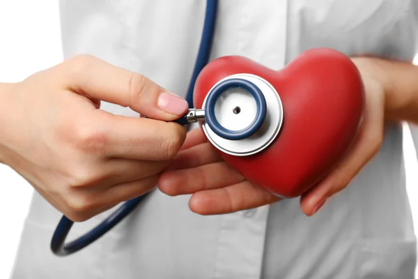 Stethoscope with heart in doctor hands, close-up — Stock Photo, Image