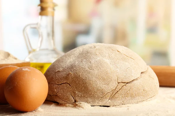 Making bread on wooden table and light blurred background