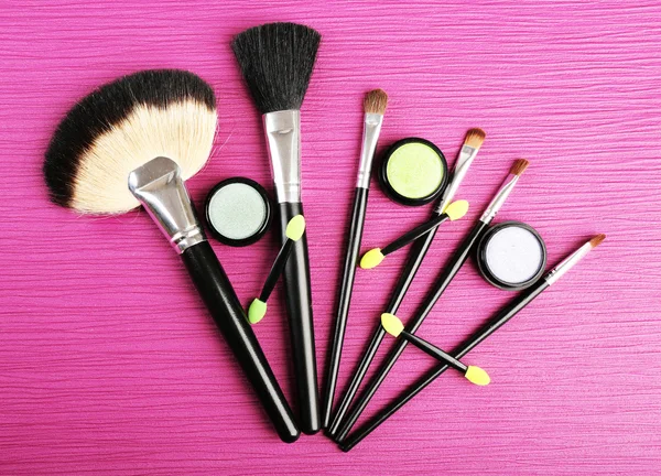 Set of makeup brushes on pink wooden table background — Stock Photo, Image