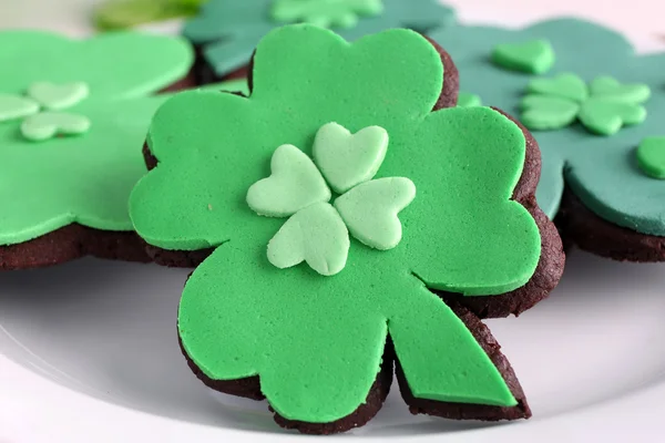 Cookies in shape of four clover leaf for St Patrick Day  on plate close up — Stock Photo, Image