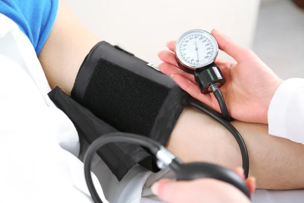 Doctor measuring patient pressure close up Stock Picture