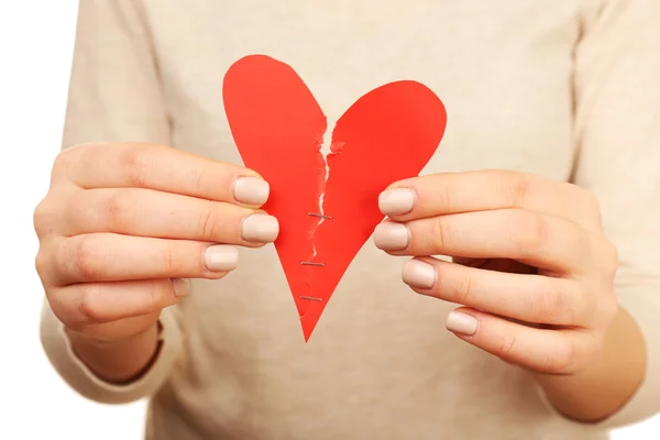 Woman holding broken heart stitched with staples close up — Stock Photo, Image