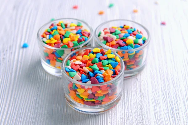 Colorful sprinkles in bowls on table close-up — Stock Photo, Image