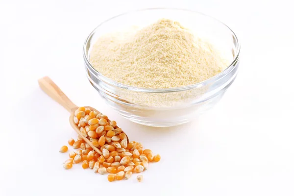 Glass bowl with flour and corn grains isolated on white — Stock Photo, Image