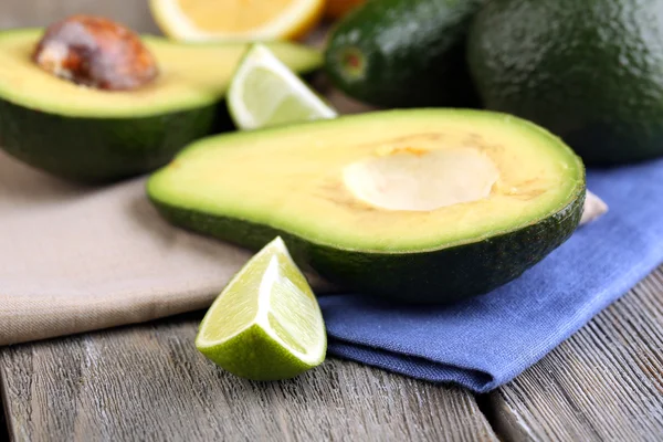 Avocado with limes on table close up — Stock Photo, Image