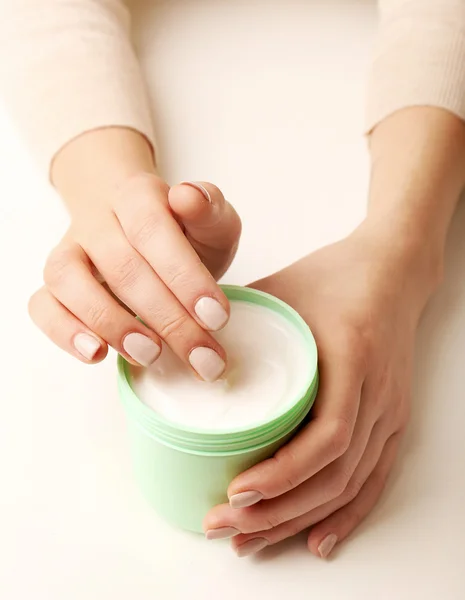Female hands holding jar of cream isolated on white — Stock Photo, Image