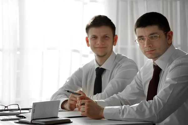 Two handsome businessmen working in office — Stock Photo, Image