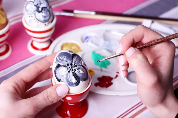 Young woman painting Easter eggs on table close up — Stock Photo, Image