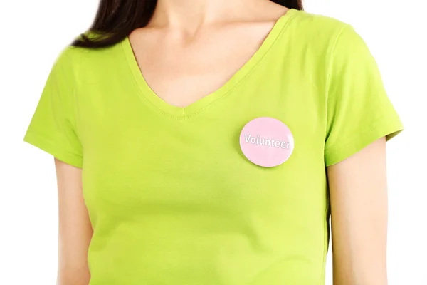 Round volunteer button on shirt of girl isolated on white — Stock Photo, Image