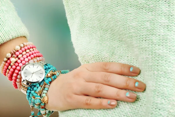 Stylish bracelets and clock on female hand close-up — Stock Photo, Image