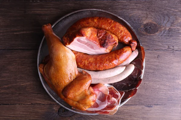 Assortment of deli meats on metal tray on color wooden background — Stock Photo, Image