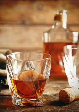 Whiskey on wooden background clipart