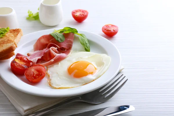 Bacon et oeufs sur fond de table en bois couleur — Photo