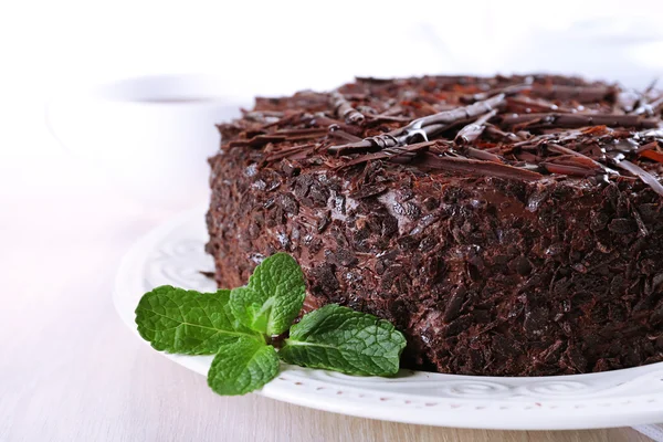 Tasty chocolate cake with cup of tea on table close up — Stock Photo, Image