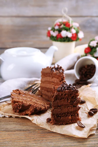 Slices of tasty chocolate cake on plate on table close up — Stock Photo, Image