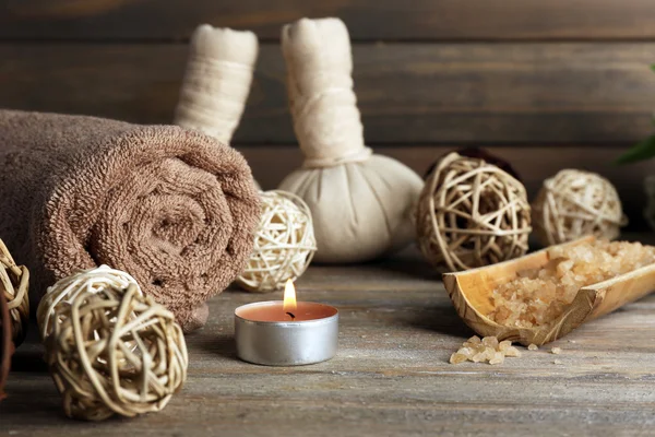 Beautiful spa composition with sea salt and massage bags on wooden background — Stock Photo, Image